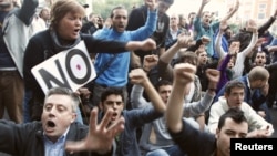 Protesters shout slogans during a demonstration outside Madrid's Parliament, September 26, 2012. 