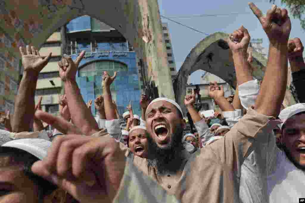 Bangladeshi activists of various Islamic political groups and other Muslims shout slogans after Friday prayers during a protest in Dhaka, Bangladesh. Thousands of Muslim devotees rallied in to denounce a court petition seeking to remove Islam as state religion in the Muslim-majority South Asian nation which is ruled by secular laws.
