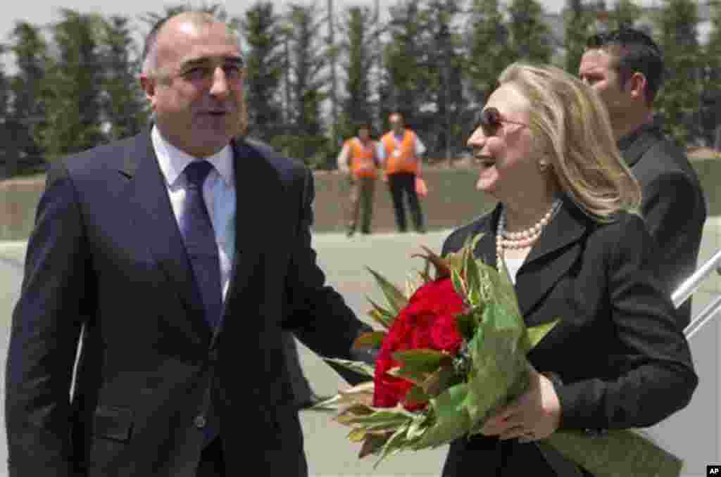 Azeri Foreign Minister Elmar Mammadyarov, left, greets US Secretary of State Hillary Rodham Clinton Wednesday June 6, 2012 upon her arrival the Heydar Aliyev International Airport in Baku, Azerbaijan. Clinton has embarked on a tour of the South Caucasus
