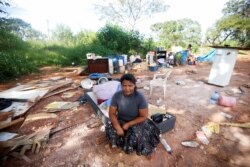 Tatiana Araujo de Sirqueira, 33, who works in waste recycling and as she says she stopped receiving emergency aid, poses for a picture in her home destroyed by local authorities, March 3, 2021. (REUTERS/Adriano Machado)