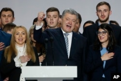 FILE - Incumbent Ukrainian President Petro Poroshenko, center, greets supporters in Kyiv, Ukraine, Jan. 29, 2019.