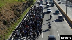 FILE - Salvadorans take part in a new caravan of migrants, heading to the United States, as they leave San Salvador, El Salvador, Jan. 16, 2019. 