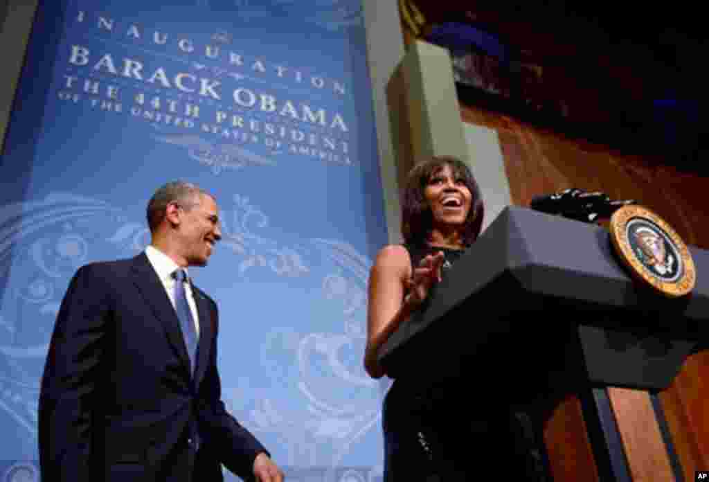 US President Barack Obama listens as First Lady Michelle Obama delivers remarks at the Inaugural Reception at the National Building Museum in Washington, DC, USA, 20 January 2013. Obama defeated Republican candidate Mitt Romney on Election Day 06 November