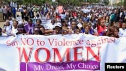 FILE - Women take part in a protest, demanding justice for a woman who was attacked and stripped recently in Nairobi by men who claimed that she was dressed indecently, in Nairobi, Kenya, Nov. 17, 2014. 