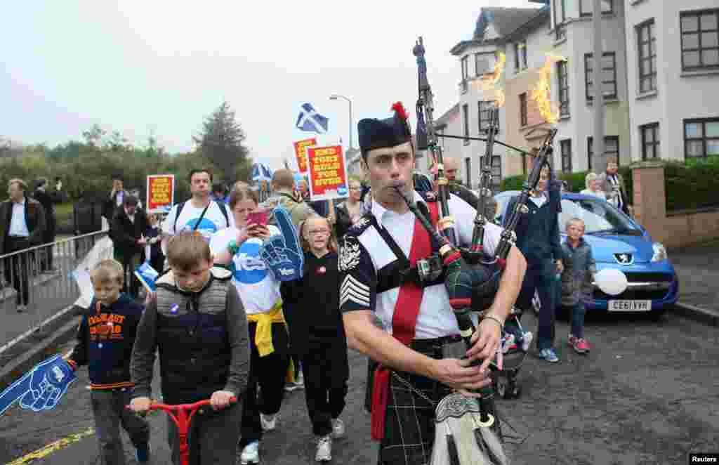 A man plays the bagpipes on a "short walk to freedom" march in Edinburgh, Scotland, Sept. 18, 2014.