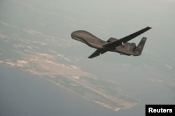 FILE - An Global Hawk drone conducts tests over Maryland in this undated U.S. Navy photo. NATO is purchasing a derivative of the Global Hawk from Northrop Grumman.