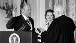 U.S. Chief Justice Warren Burger administers the oath of office to Gerald Ford, whose wife, Betty, is at center