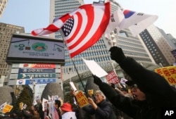 FILE - South Korean protesters wave U.S. and South Korean flags at a rally to support the deployment of THAAD, an advanced U.S. missile defense system, Feb, 15, 2017.