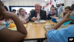 Agriculture Secretary Sonny Perdue eats lunch with students at the Catoctin Elementary School in Leesburg, Virginia, May 1, 2017. Perdue unveiled a new rule on school lunches as the Trump administration and other Republicans press for flexibility after eight years of the emphasis on healthy eating. 