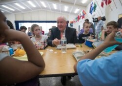 Agriculture Secretary Sonny Perdue eats lunch with students at the Catoctin Elementary School in Leesburg, Virginia, May 1, 2017. Perdue announced new rules on school lunches as the Trump administration wants more choices for school meals.