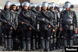 Anti-riot policemen hold rifles during security preparations ahead of Friday's planned protest by hard-line Muslim groups in Jakarta, Indonesia, Nov. 2, 2016.