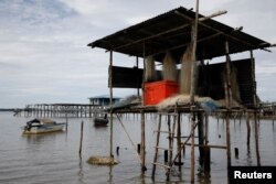 Fishing nets hang from a shack in a village farming sea cucumber in Mapan Mapan, Sabah, Malaysia, July 7, 2018.