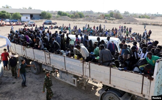 Migrants ride in a truck to a detention center in the coastal city of Sabratha, Libya, Oct. 7, 2017.