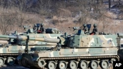 South Korean army soldiers ride K-9 self-propelled howitzers in Paju, South Korea, near the border with North Korea, Jan. 11, 2022.