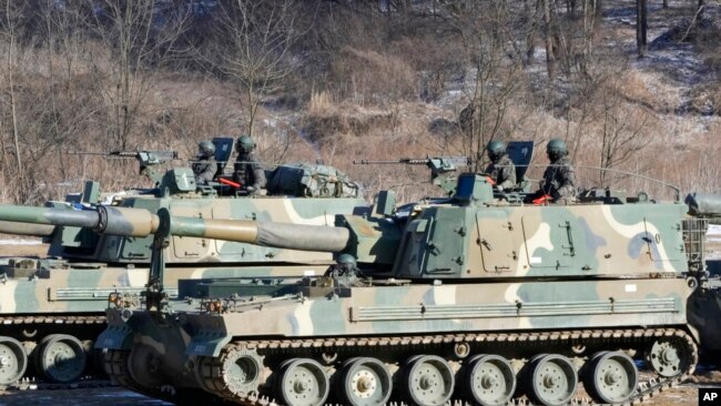 South Korean army soldiers ride K-9 self-propelled howitzers in Paju, South Korea, near the border with North Korea, Jan. 11, 2022.