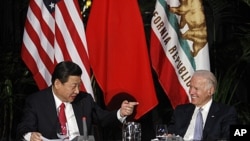 Chinese Vice President Xi Jinping (L) and his US counterpart Joe Biden address a meeting with governors and Chinese provincial officials at Walt Disney Hall in Los Angeles, February 17, 2012.