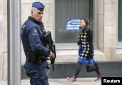 A Belgian police officer secures the area around the European Council headquarters following recent bomb attacks in the Brussels metro and at Belgian international airport of Zaventem, in Brussels, Belgium, March 30, 2016.