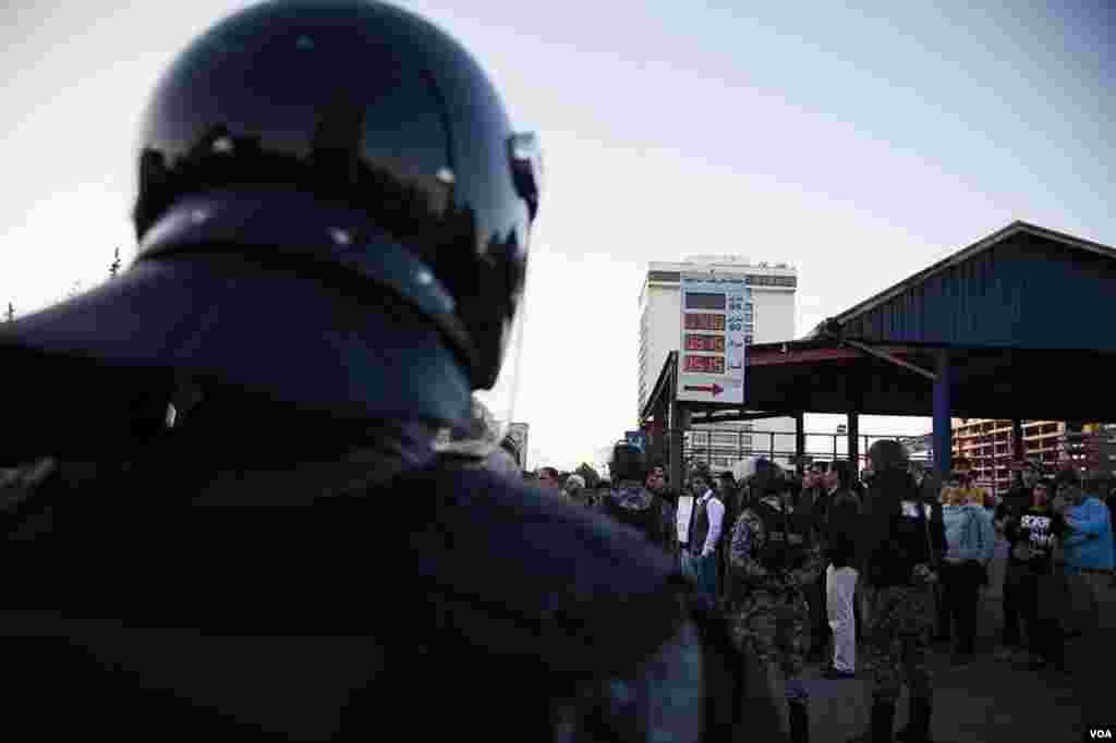 Protesters gathered near a gas station. Subsidy cuts have led to, among other things, a sharp increase in fuel prices. (Y. Weeks for VOA)