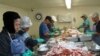 In a refrigerated workshop, employees from Laos and Thailand crack crab shells for up to 12 hours a day in Bayou La Batre, Alabama.