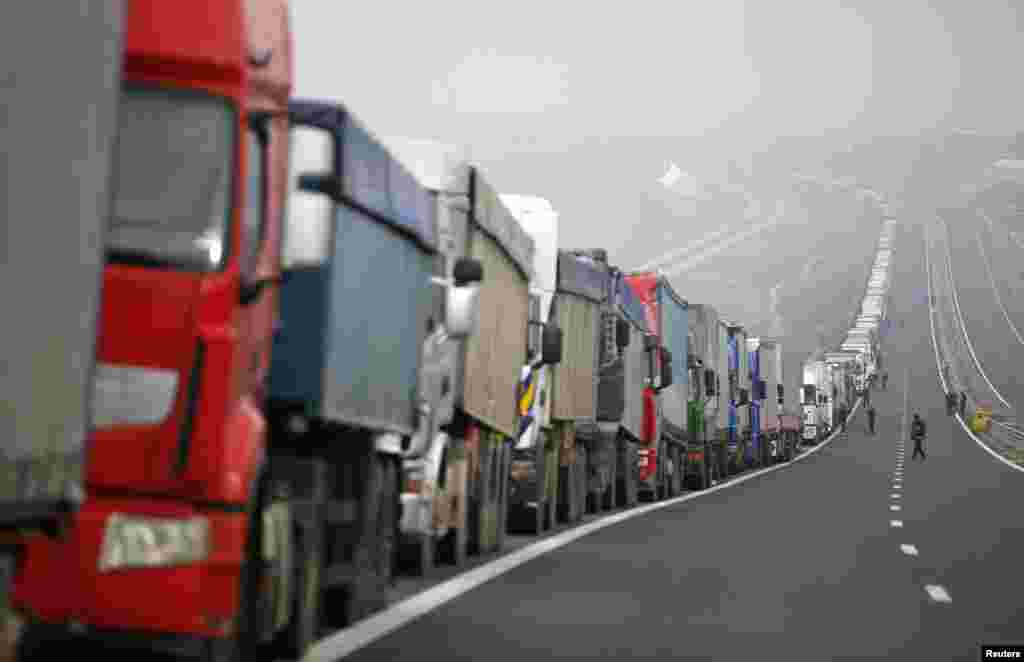 Trucks are seen on a highway near the Kulata border crossing between Bulgaria and Greece. Bulgarian truckers staged a counter-blockade at a checkpoint on the country's border with Greece, after Greek protesters failed to keep a promise to lift their own blockade for a few hours a day.
