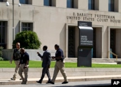 FILE - U.S. marshalls move outside U.S. District Court in Washington, June 28, 2014.