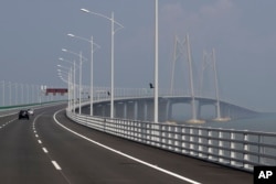 Cars drive on the Hong Kong-Zhuhai-Macau Bridge, in Zhuhai city, south China's Guangdong province, March 28, 2018. The Hong Kong-Zhuhai-Macau Bridge, the world's longest cross-sea project, which has a total length of 55 kilometers.