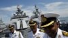 Indian navy personnel speak to the media onboard their Shivalik-class stealth multi-role frigate, INS Satpura