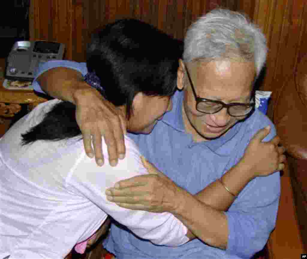 An unidentified relative, left, hugs Win Tin, 78, political prisoner at his friend's house following his release in Yangon, Myanmar, Tuesday, Sept. 23, 2008. Myanmar's longest-serving political prisoner, journalist Win Tin, was freed Tuesday after 19 year