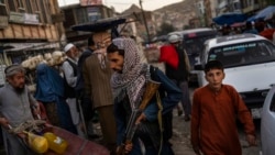 FILE - Taliban fighters patrol a market in Kabul's Old City, Afghanistan, Sept. 14, 2021.