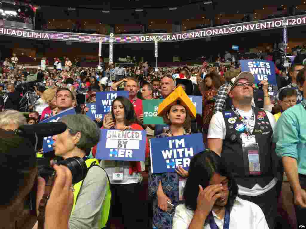 A Hillary Clinton supporter stands next to a Bernie Sanders supporter at the Democratic National Convention, July 26, 2016.