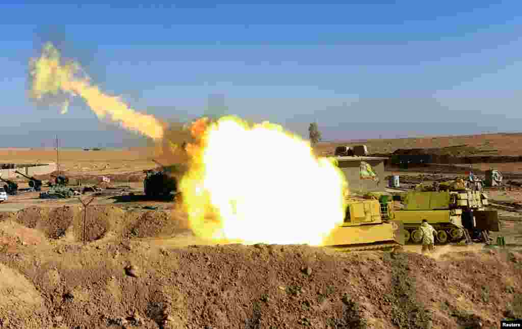 Pasukan Irak menembakkan artileri ke arah posisi militan ISIS di kota Mosul, dari desa Adhbah, selatan Mosul.