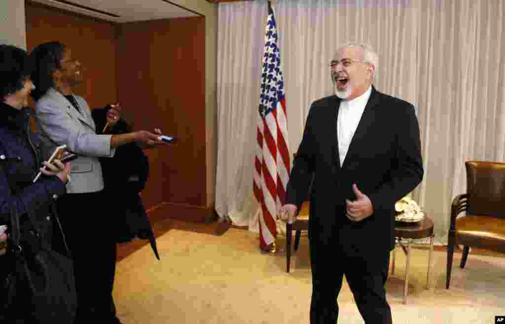 Iranian Foreign Minister Mohammad Javad Zarif laughs with reporters before meeting with U.S. Secretary of State John Kerry in Geneva, Switzerland, Jan. 14, 2015.