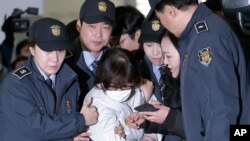 FILE - Choi Soon-sil, the jailed confidante of disgraced South Korean President Park Geun-hye, arrives for questioning into her suspected role in political scandal at the office of the independent counsel in Seoul, South Korea, Dec. 24, 2016.