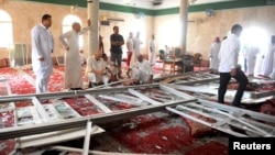 Family members of victims and well wishers are seen after a suicide bomb attack at the Imam Ali mosque in the village of al-Qadeeh in the eastern province of Gatif, Saudi Arabia, May 22, 2015.