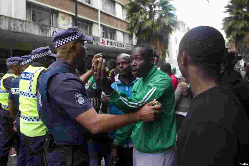 Police encourage a group of foreign nationals to move back to their homes after a peace march in Durban, April 16, 2015.