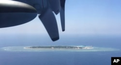 FILE - In this March 23, 2016, file photo, an aerial view is seen from a military plane carrying international journalists of the Taiwan-controlled Taiping island, also known as Itu Aba, in the Spratly archipelago, roughly 1600 kms. (1000 miles) in the So