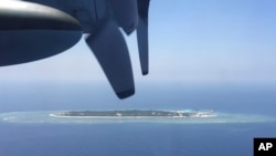 FILE - An aerial view is seen from a military plane carrying international journalists of the Taiwan-controlled Taiping island, also known as Itu Aba, in the Spratly archipelago.