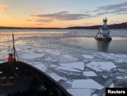 U.S. Coast Guard Cutter Penobscot Bay helps break free tug Stephanie Dann from the ice on the Hudson River near Kingston, New York, U.S., January 2, 2018. Picture taken on January 2, 2018. U.S. Coast Guard photo/Handout via REUTERS