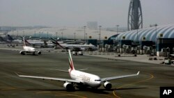 FILE - An Emirates Airlines passenger jet taxis on the tarmac at Dubai International airport in Dubai, United Arab Emirates, April 20, 2010.