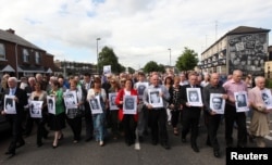 FILE - Relatives of those killed during Bloody Sunday make their way from the Bogside to the Guildhall to read the Saville report, Londonderry in Northern Ireland, June 15, 2010.