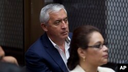 FILE - Guatemala's former President Otto Perez Molina, and his former Vice-President Roxana Baldetti, listen during their court hearing in Guatemala City, May 6, 2016. Twenty-three people were arrested Thursday on charges related to the alleged illegal financing of the political party that carried Perez Molina to power, Guatemalan authorities said.