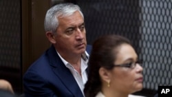 FILE - Former Guatemalan President Otto Perez Molina and his former vice president, Roxanna Baldetti, listen during a court hearing in Guatemala City, May 6, 2016. Twenty-three people had been arrested on charges related to the alleged illegal financing of the political party that carried Perez Molina to power, Guatemalan authorities said.
