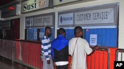 Relatives of passengers on the missing Trigana Air Service flight stand in front of its closed offices at Sentani airport in Jayapura, Papua province, Indonesia, Aug. 16, 2015.