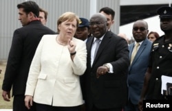 FILE - German Chancellor Angela Merkel is welcomed by Ghana's Vice President Bawumia at the Jubilee Airport in Accra, Ghana, Aug. 30, 2018.