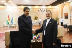 Venezuela's President Nicolas Maduro (L) shakes hands with Iran's Vice President Eshaq Jahangiri as they meet during the 4th Gas Exporting Countries Forum in Santa Cruz, Bolivia, Nov. 24, 2017.