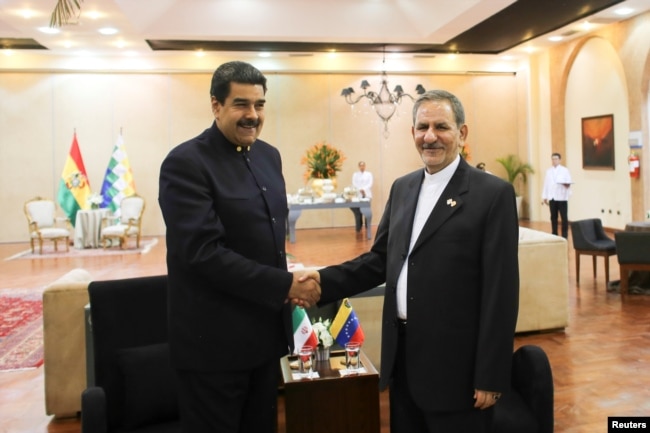 Venezuela's President Nicolas Maduro (L) shakes hands with Iran's Vice President Eshaq Jahangiri as they meet during the 4th Gas Exporting Countries Forum in Santa Cruz, Bolivia, Nov. 24, 2017.