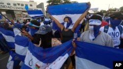 Anti-government protesters march outside the Central American University in Managua, Nicaragua, Sept. 26, 2018, before police blocked the march from reaching its planned destination, the local U.N. headquarters. 