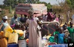 FILE - Refugees arrive in Uganda after fleeing violence in South Sudan, Jan. 6 2014.