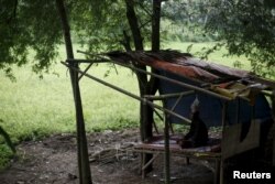 Deden, a teenager whose father says suffers from mental illness, lives chained to a tree under a shelter next to a rice paddy near his family home in Longkewang village in Serang, Banten province, Indonesia, March 23, 2016.