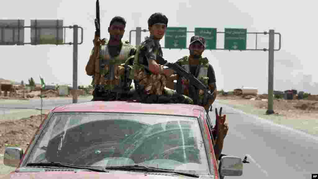 Shiite militiamen patrol in Amirli, Iraq, after breaking a siege by the Islamic State extremist group on the town, about 170 kilometers (105 miles) north of Baghdad, Aug. 31, 2014. 